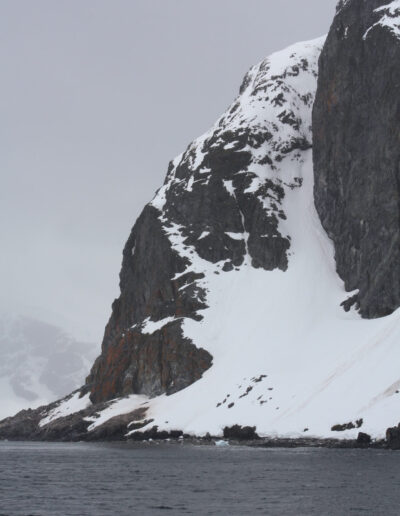 snow covered rock and hazy gray skies